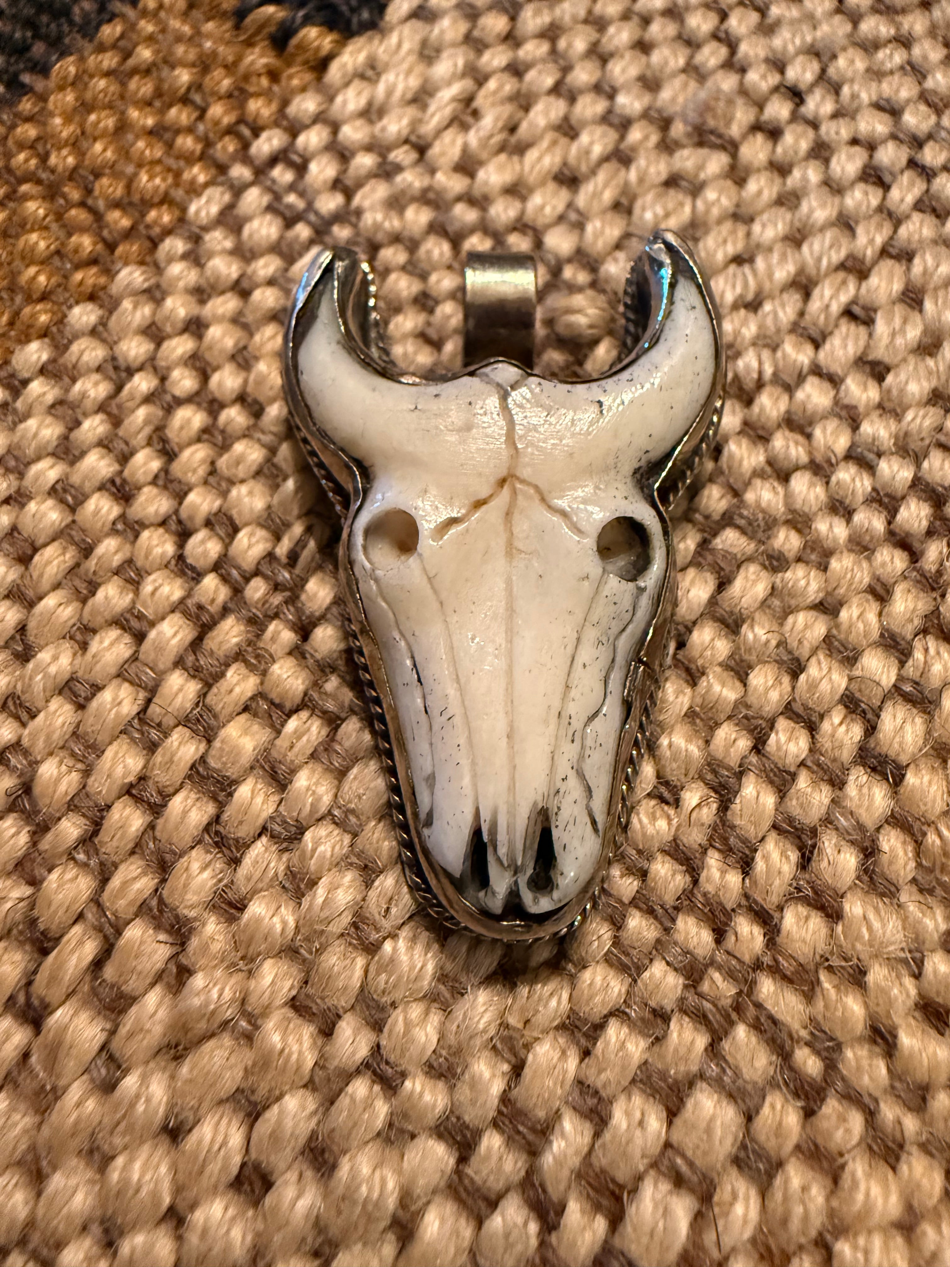 Carved Bone Skull Pendant with Silver Bezel Setting.