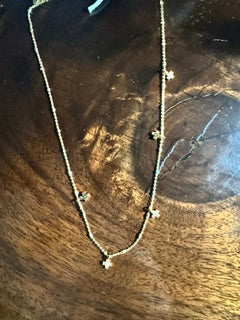 Five Crosses hanging on a gold chain