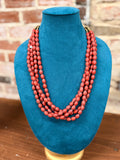 Multi-strand Coral Bead Necklace with Brass Accents and a Fiber Cord Closure